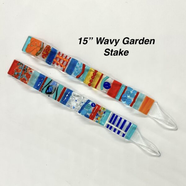 Vibrant glass garden stake with intricate designs, showcasing a burst of colors and artistic patterns