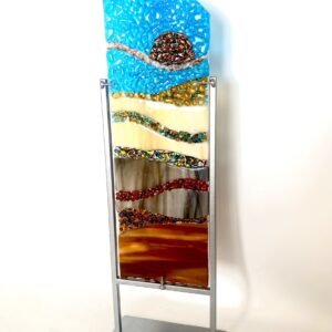 A glass sculpture on a metal stand, showcasing elegance and creativity