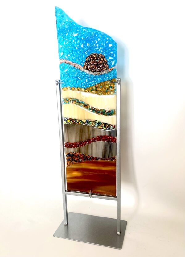 A glass sculpture on a metal stand, showcasing elegance and creativity