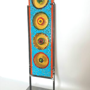 Vibrant metal sculpture featuring four plates, colorful and modern design, artistic masterpiece