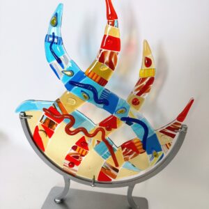 A vibrant glass sculpture on a sleek metal stand, adding a pop of color and elegance to any space