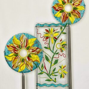 Colorful glass flowers displayed on metal stand