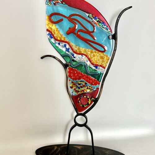 Colorful glass sculpture on stand, a playful collage