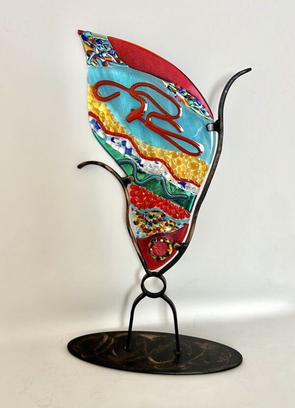 Colorful glass sculpture on stand, a playful collage